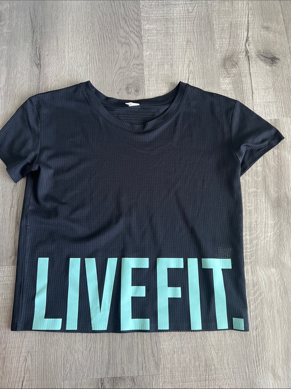 LiveFit Women’s Black Mesh Logo Crop Tee - Aqua Teal Lettering